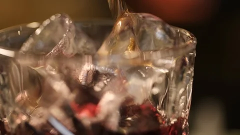 Macro frame. liquid is poured into a glass of ice. Cola is beautifully poured Stock Footage 106936943