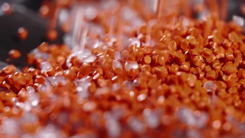 Macro frame of white and orange plastic granules. The polymer composite is Video stock 260683458