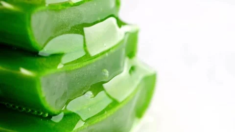Macro of fresh aloe vera slices with juice dripping on white background Stock-Footage 333486872