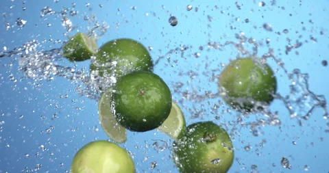 Macro of fresh bio green lime lemon fruit flying with splashing water drops Stock-Footage 269926628