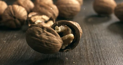 Macro of fresh bio organic dried walnut is falling on wooden rustic table Stock Footage 268832308