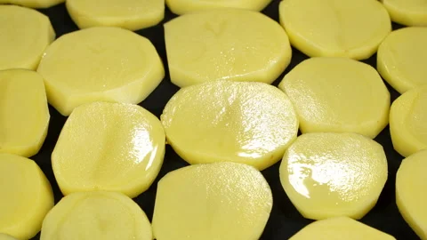 Macro Fresh Raw Potato Slices Rotating on Turntable Video stock 344025995