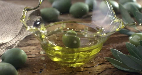Macro of fresh ripe red olive falls in organic golden extra virgin olive oil Stock Footage 268458918