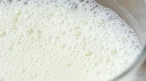 Macro of frothy milk bubbles bursting Stock Footage 67195573