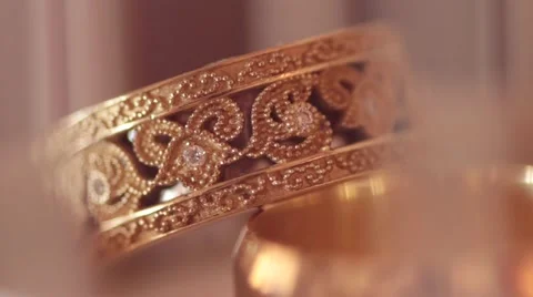 Macro of the golden bridal rings with diamonds on blurred pastel background Stock-Footage 59183005