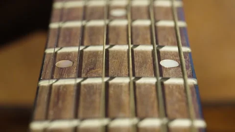 Macro Of Golden Guitar Strings And Shadow Moving Past Fretboard Stock Footage 328583759