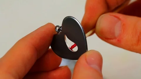 Macro of a goldsmith cutting and filing the steel to make a ring. Concept Stock Footage 120006498