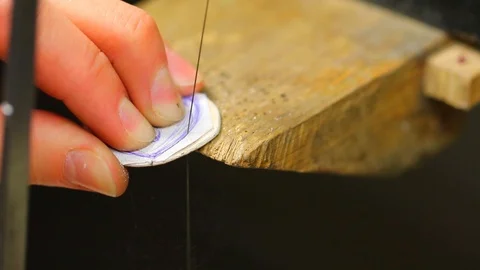 Macro of a goldsmith cutting and filing the steel to make a ring. Concept Stock Footage 120008550