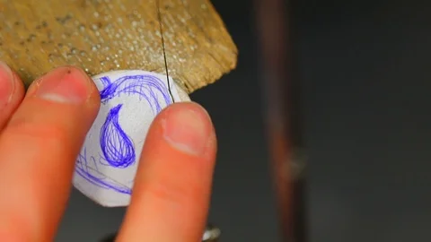 Macro of a goldsmith cutting and filing the steel to make a ring. Concept Stock Footage 120008575