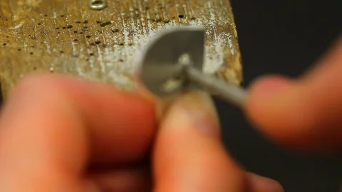 Macro of a goldsmith cutting and filing the steel to make a ring. Concept Stock Footage 120008980