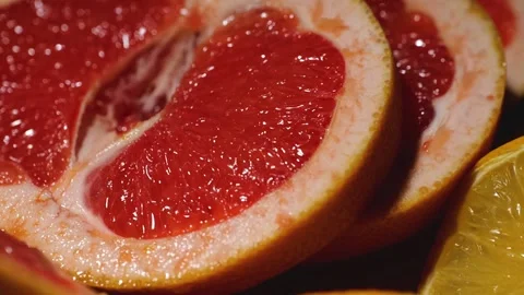 Macro grapefruit, oranges, lemon and pineapple sliced on a bamboo board Stock Footage 146146544