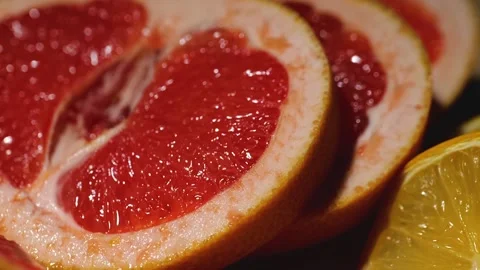 Macro grapefruit, oranges, lemon and pineapple sliced on a bamboo board Stock Footage 146146590