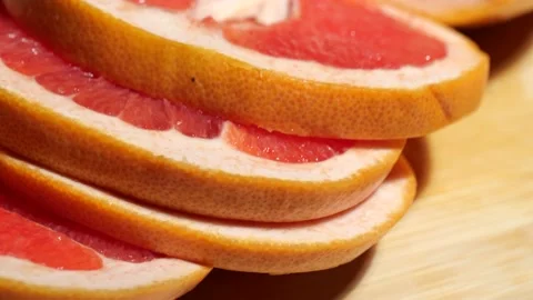 Macro grapefruit sliced on a bamboo board Stock Footage 146147379