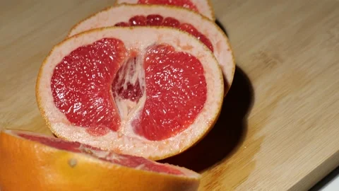 Macro grapefruit sliced on a bamboo board Stock Footage 146147570