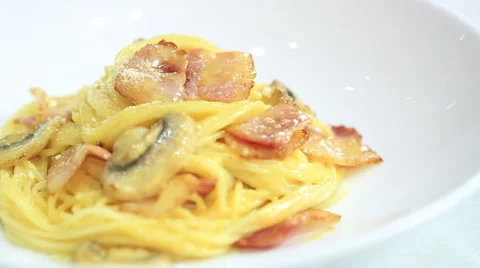 Macro of grating cheese on spaghetti carbonara in the white plate, close up Stock Footage 51411938