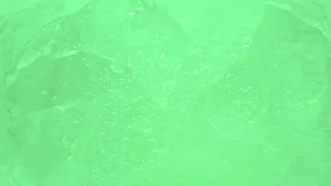 Macro green broken ice texture with splashing water surface, drops and ripples Stock Footage 233145360