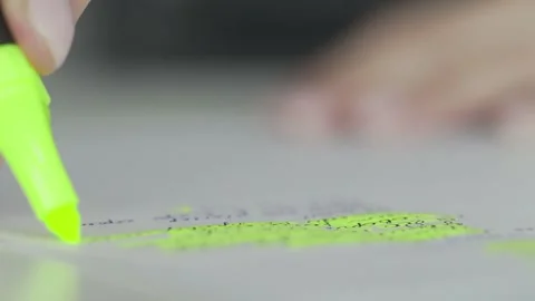 Macro of the green Highlighter marker selecting a phrase in the text Stock Footage 130927726