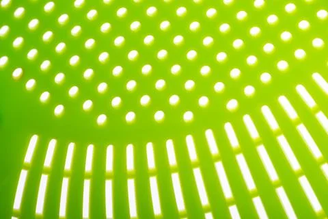 Macro of a green plastic colander Stockfoto's