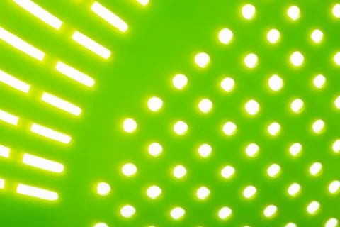 Macro of a green plastic colander Фото