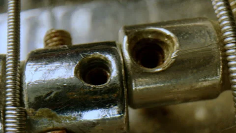 Macro of Guitar Bridge Saddle with Wound String Wrapped around It Stock Footage 283464886