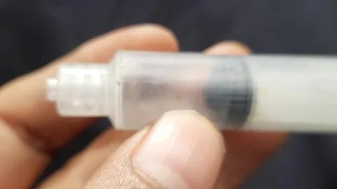 Macro Hand Holding Syringe Pump Stock Footage 310176257