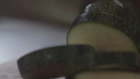 Macro, Hand with Kitchen Knife Cuts Zucchini Zucchini On Wooden Board Stock Footage 157682532