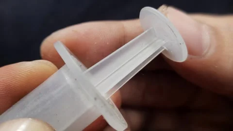 Macro Hand Pumping Syringe Plunger Stock Footage 310176418