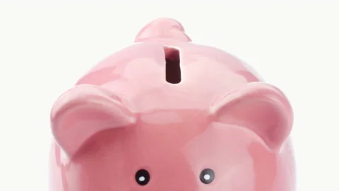 Macro hand putting coin one euro into piggy bank on white background Stock Footage 140378878