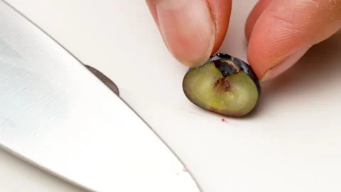 Macro Hands Cutting Fresh Blueberry in Half with Knife Isolated 4K Stock Footage 320658922