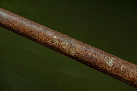 Macro of heavy rust texture on industrial iron railing pipe at night Stock Photos