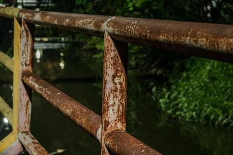 Macro of heavy rust texture on industrial iron railing near midnight Stock Photos