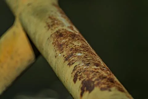 Macro of heavy rust texture on industrial iron railing near midnight Stock Photos