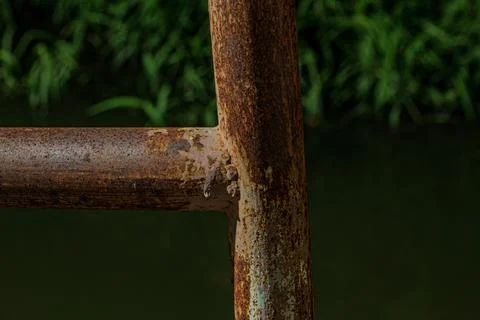 Macro of heavy rust texture on T-shape iron pipe joint at night Stock Photos