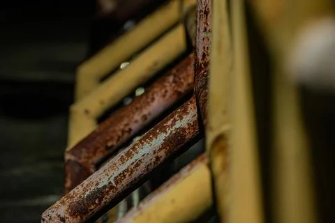 Macro of heavy rust texture on yellow iron railing Stock Photos