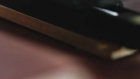 Macro hot stamping machine embossing logo into brown leather surface for Stock Footage 323326795