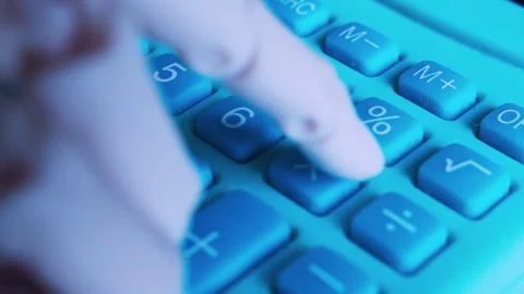 Macro of humanoid robot finger typing on office calculator. Stock Footage 337912621