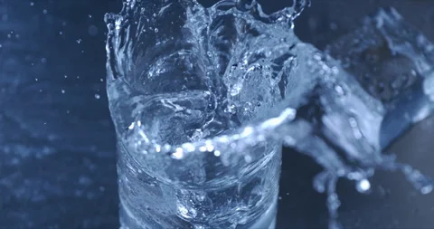 Macro of ice cubes falling in transparent glass with pure water Video stock 269383191