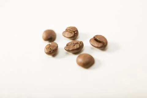 Macro image of dark aromatic coffee beans  on   white background with  copy s Stock Photos
