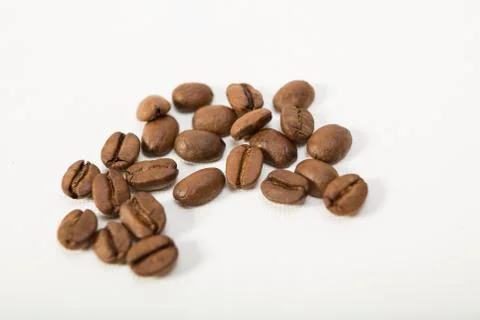 Macro image of dark aromatic coffee beans  on   white background with  copy s Stock Photos