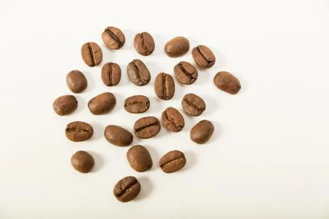 Macro image of dark aromatic coffee beans  on   white background with  copy s Stock Photos