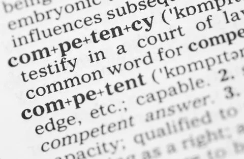 Macro image of dictionary definition of competency Stock Photos