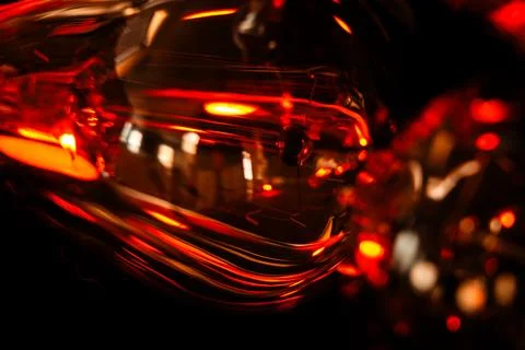 Macro image of filaments inside edison bulb in warm light Stock Photos