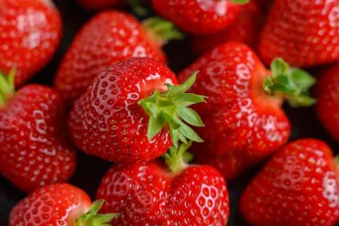 Macro image of fresh strawberries on dark background Stock Photos