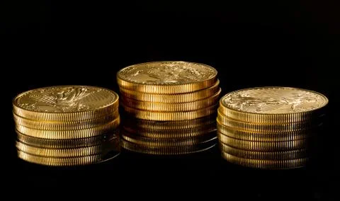 Macro image of gold eagle coin on stack Stock Photos
