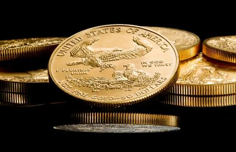 Macro image of gold eagle coin on stack Stock Photos