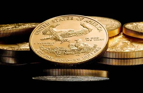 Macro image of gold eagle coin on stack Close up of a solid gold eagle one... Stock Photos