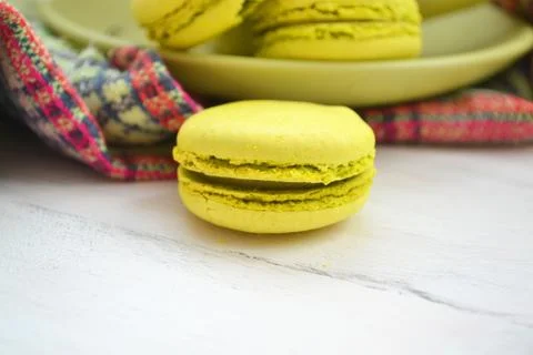 Macro image of a green macaron on a white shabby surface. Stock Photos