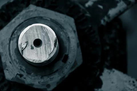 Macro image of machined bolt through nut and out of focus machine parts Fotos Stock