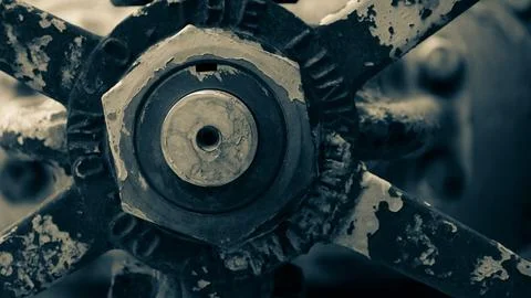 Macro image of machined bolt through nut and out of focus machine parts Photos