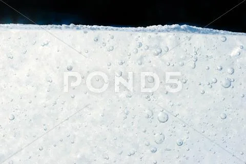 Macro image of melting ice under snowcover Stock Photos